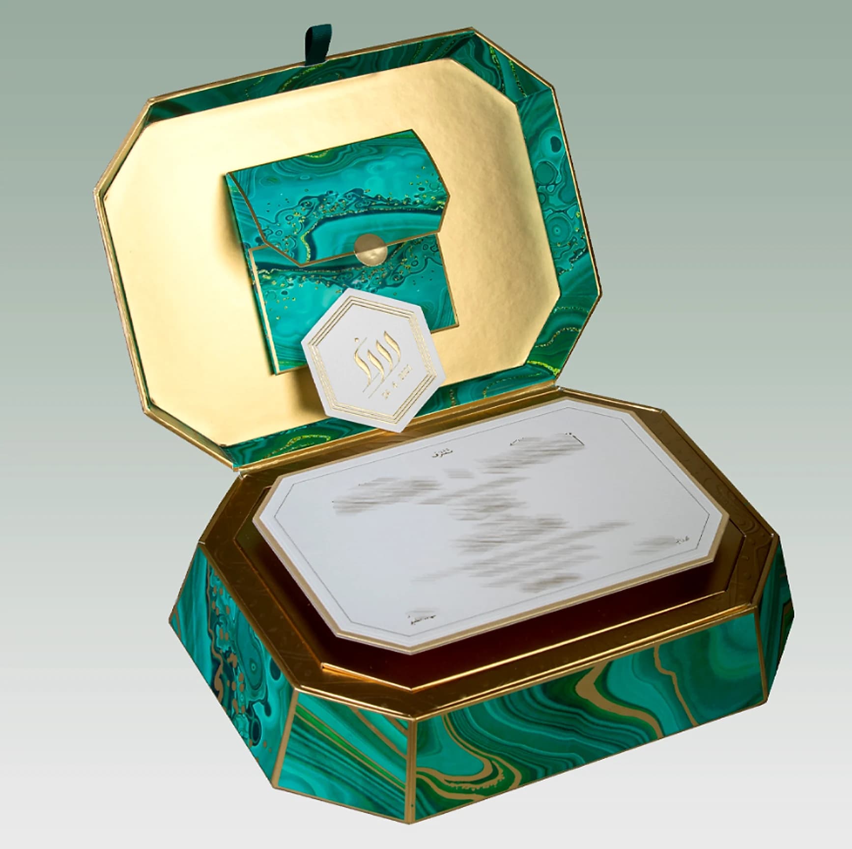 Green marble-pattern gift box with a gold interior, a hexagonal tag and an invitation card